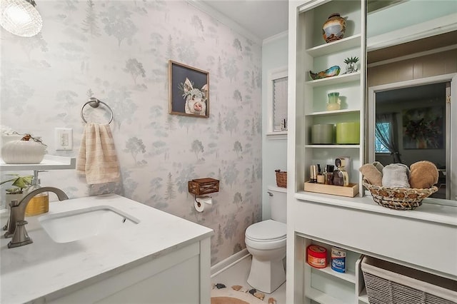 bathroom featuring crown molding, vanity, toilet, and tile patterned floors