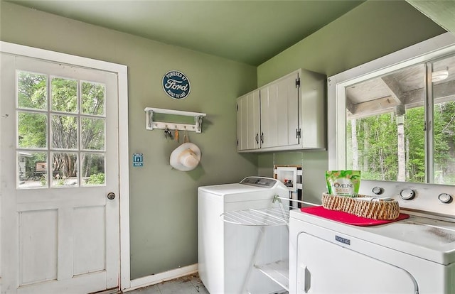 washroom with washer and clothes dryer and cabinets