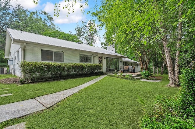 single story home featuring central AC unit, a patio area, and a front yard