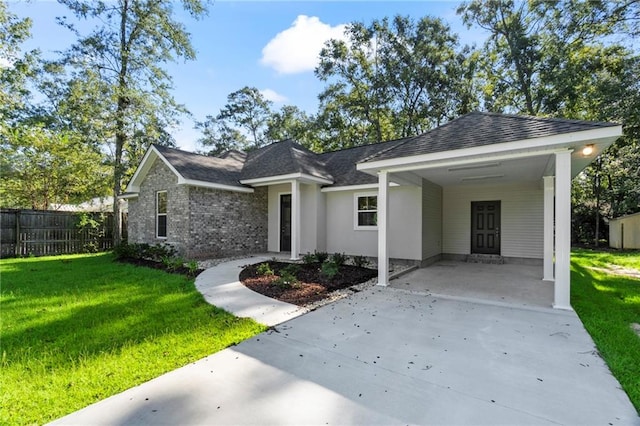 ranch-style house featuring a front yard and a carport