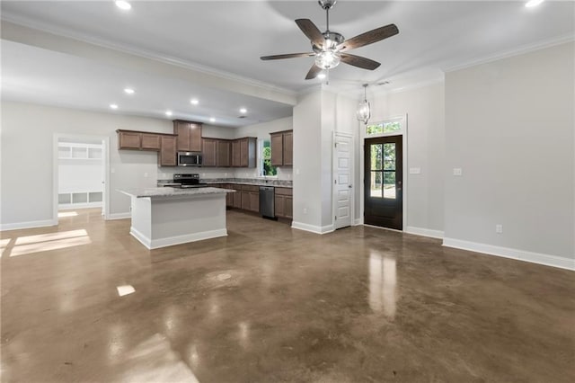 kitchen with a kitchen island, stainless steel appliances, crown molding, light stone countertops, and ceiling fan