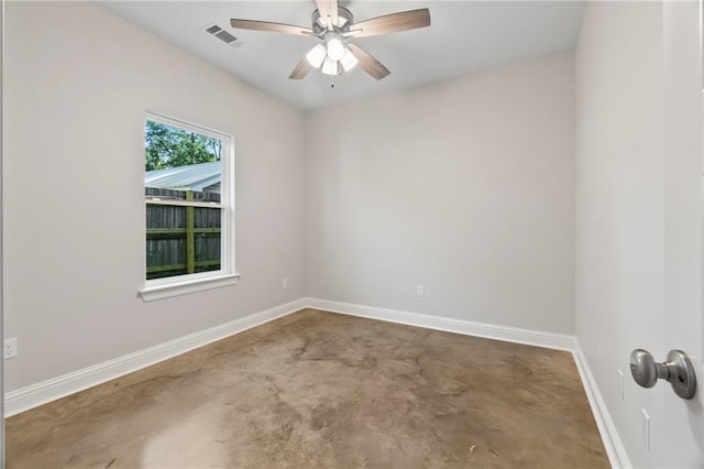 spare room featuring ceiling fan and concrete floors