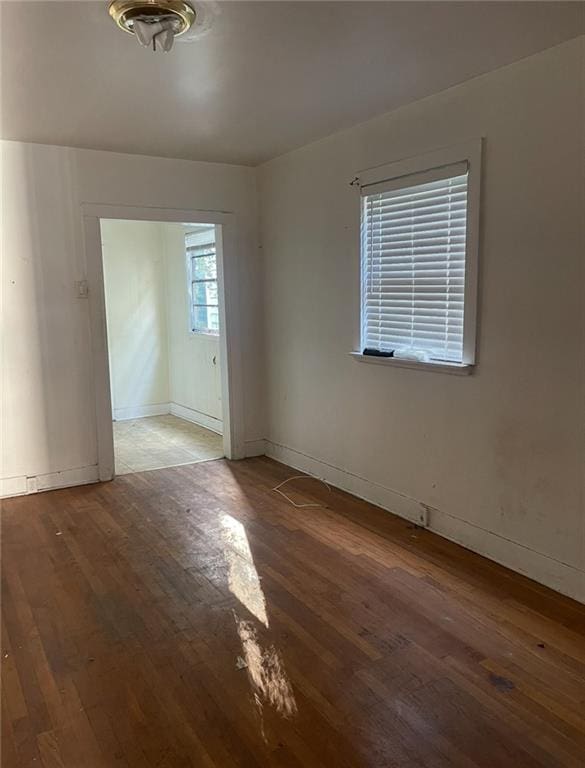 empty room featuring dark hardwood / wood-style flooring