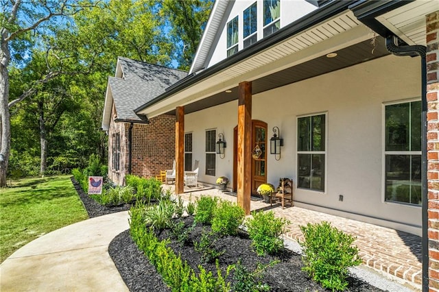 entrance to property with a yard and a porch