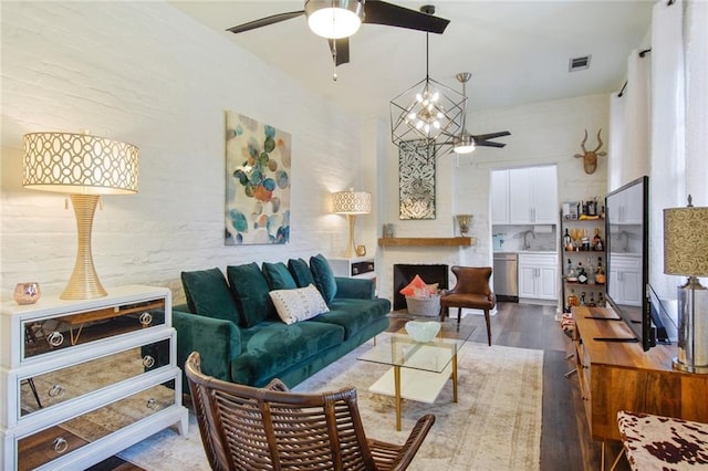 living room with hardwood / wood-style floors, sink, and a chandelier