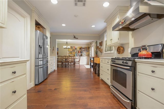 kitchen featuring pendant lighting, ornamental molding, appliances with stainless steel finishes, dark hardwood / wood-style floors, and range hood