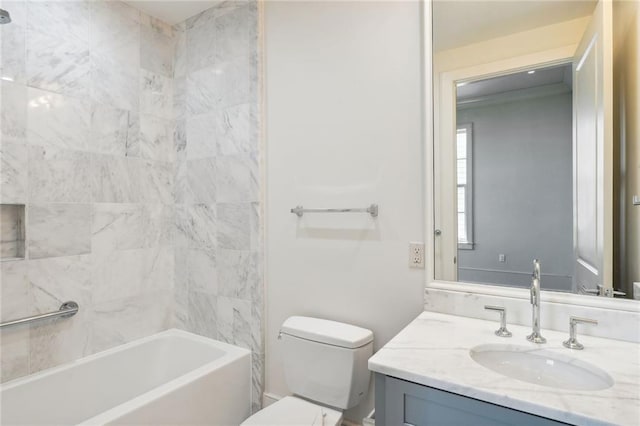 full bathroom featuring tiled shower / bath combo, vanity, and toilet