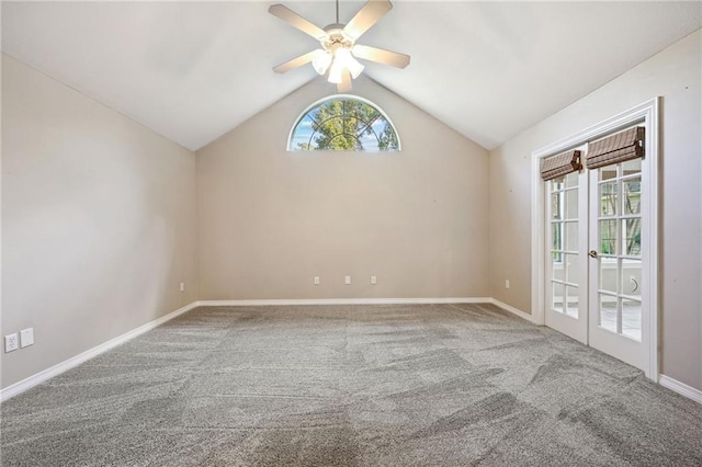 spare room featuring carpet floors, vaulted ceiling, and ceiling fan