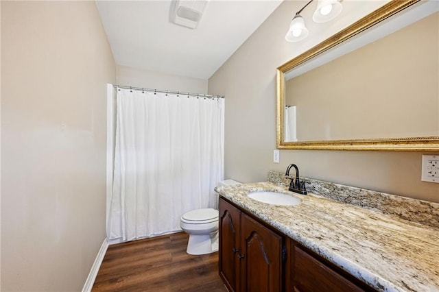 bathroom with toilet, vanity, hardwood / wood-style floors, and a shower with curtain