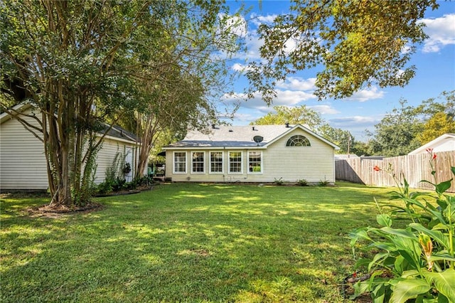 back of house with a yard