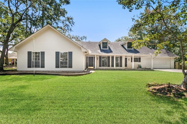 rear view of house with a garage and a lawn