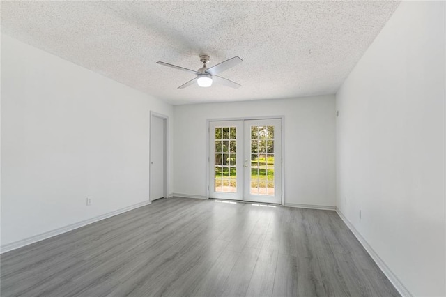 unfurnished room with french doors, a textured ceiling, ceiling fan, and hardwood / wood-style floors