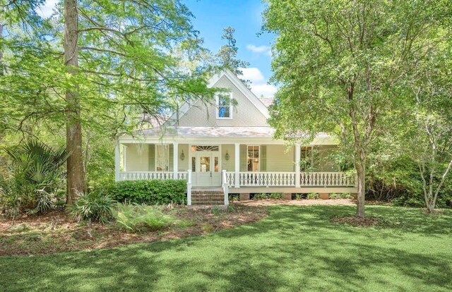 73527 Military Rd, Covington, LA 70435 - farmhouse-style home with covered porch and a front yard