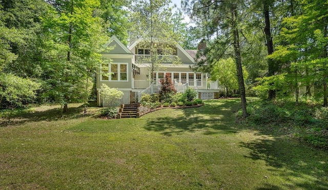 rear view of house featuring a yard