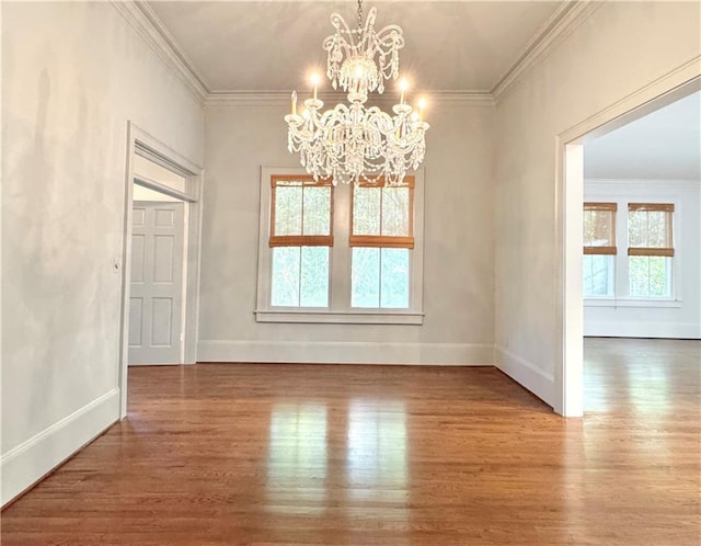 73527 Military Rd, Covington, LA 70435 - unfurnished dining area with a chandelier, wood finished floors, crown molding, and baseboards