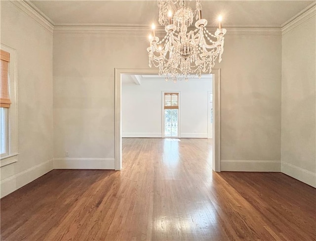 unfurnished dining area featuring a notable chandelier, ornamental molding, and hardwood / wood-style flooring