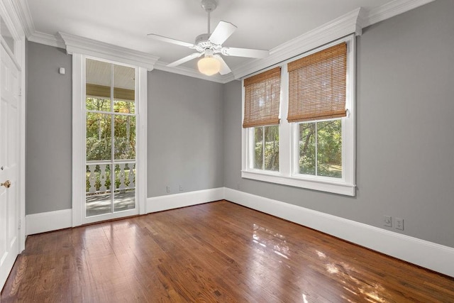 empty room with ceiling fan, crown molding, plenty of natural light, and hardwood / wood-style floors