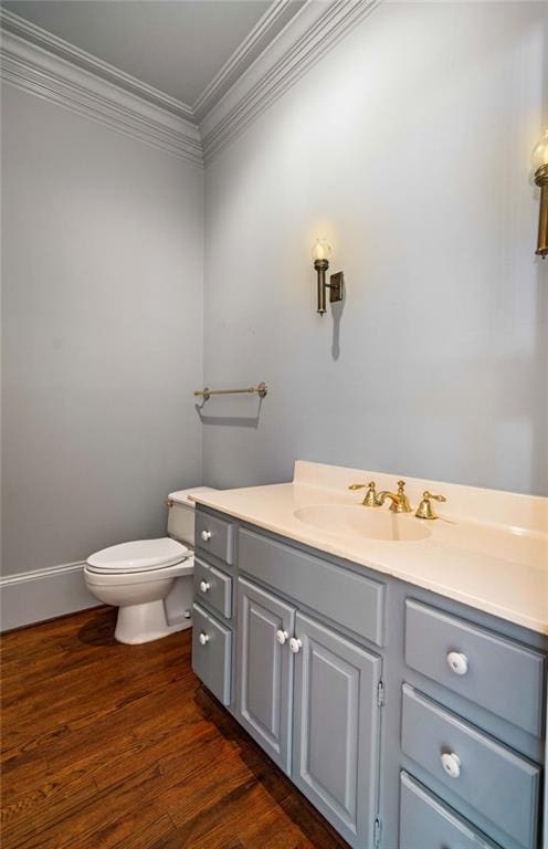 73527 Military Rd, Covington, LA 70435 - half bathroom with vanity, toilet, crown molding, and wood finished floors