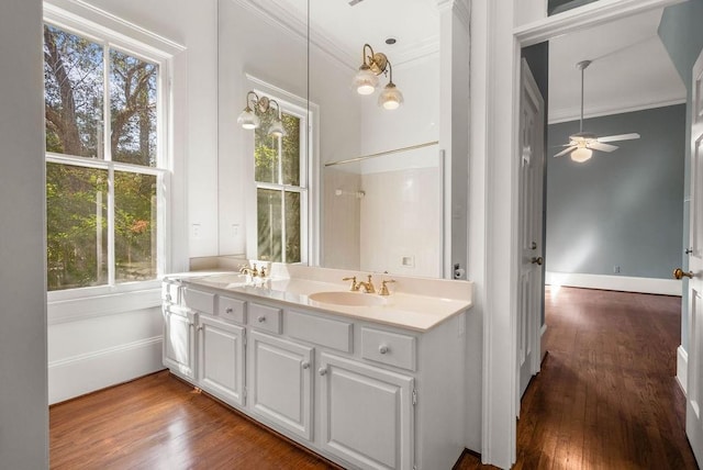 bathroom with a wealth of natural light, vanity, hardwood / wood-style floors, and ceiling fan