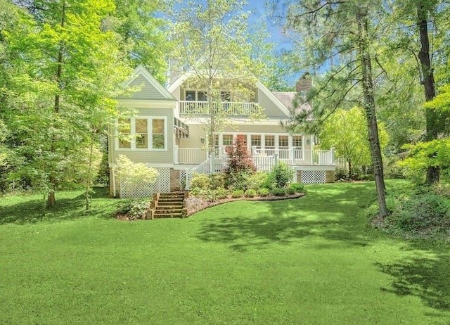 73527 Military Rd, Covington, LA 70435 - back of house featuring stairs, a balcony, a chimney, a lawn, and a porch