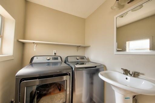 laundry area with sink and washing machine and clothes dryer