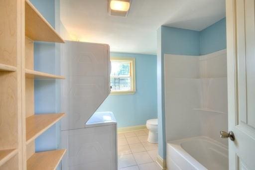 bathroom with bathtub / shower combination, tile patterned floors, and toilet