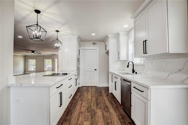 kitchen featuring white cabinetry, kitchen peninsula, stainless steel appliances, dark hardwood / wood-style floors, and sink