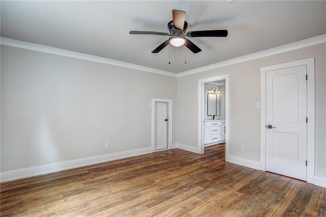 unfurnished bedroom with ensuite bath, ceiling fan, dark hardwood / wood-style floors, and crown molding