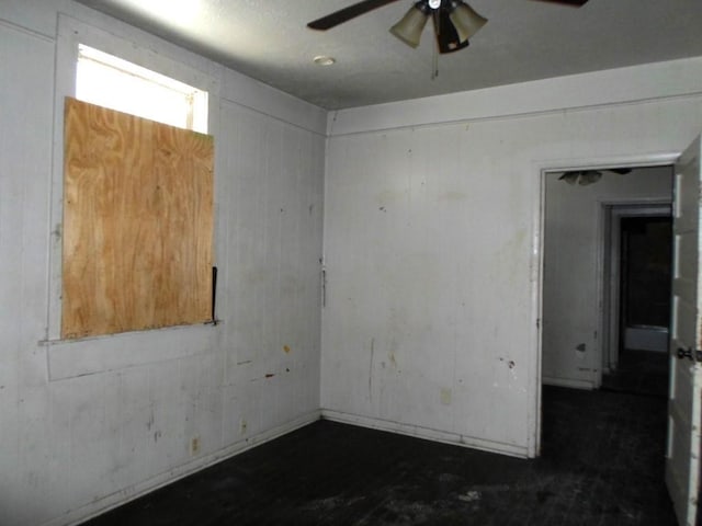 unfurnished room with ceiling fan