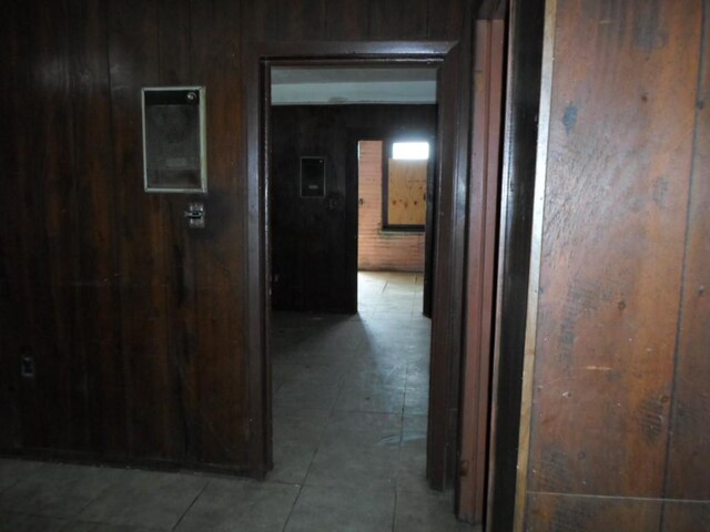 hallway with wood walls