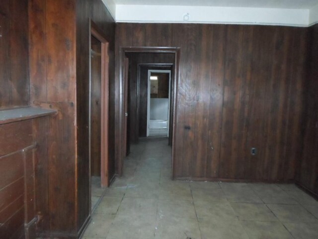 hallway with wood walls