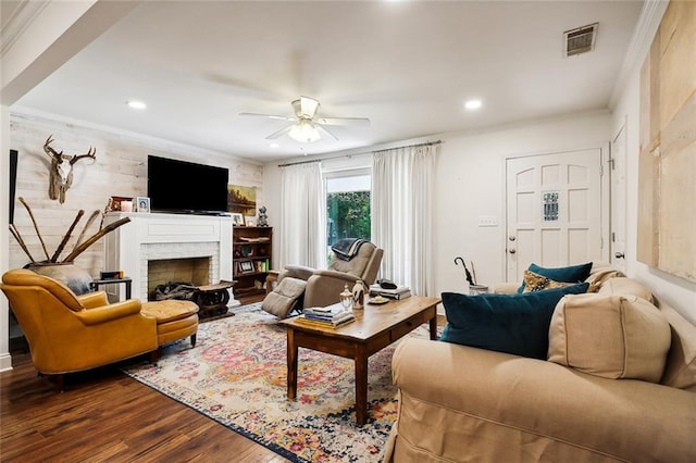 living room with ceiling fan, hardwood / wood-style flooring, and ornamental molding