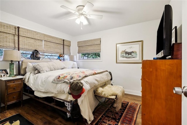 bedroom featuring ceiling fan and dark hardwood / wood-style floors