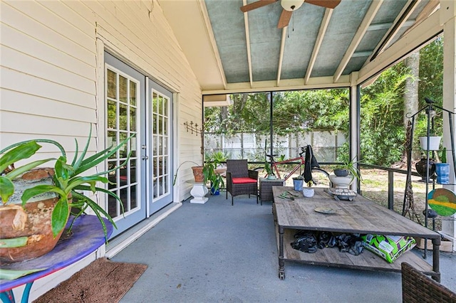 sunroom with vaulted ceiling, ceiling fan, and french doors