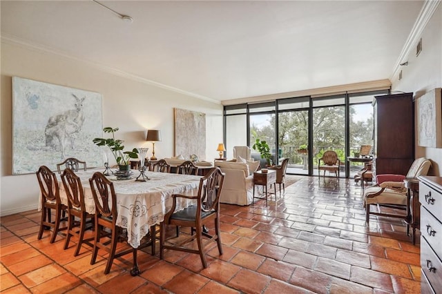 dining room with ornamental molding and floor to ceiling windows