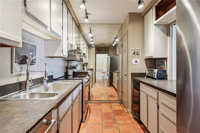 kitchen with white cabinets, sink, beverage cooler, track lighting, and stainless steel appliances