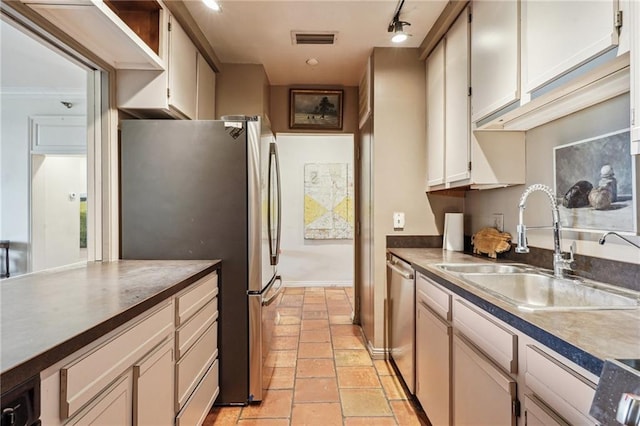 kitchen with sink, track lighting, and stainless steel appliances