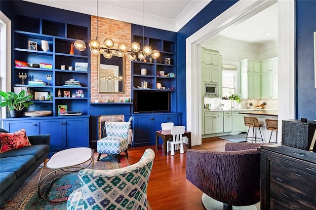 sitting room featuring crown molding, built in shelves, and dark hardwood / wood-style flooring