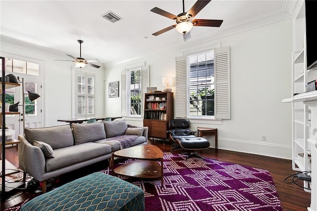 living room with ornamental molding, a wealth of natural light, a fireplace, and hardwood / wood-style floors