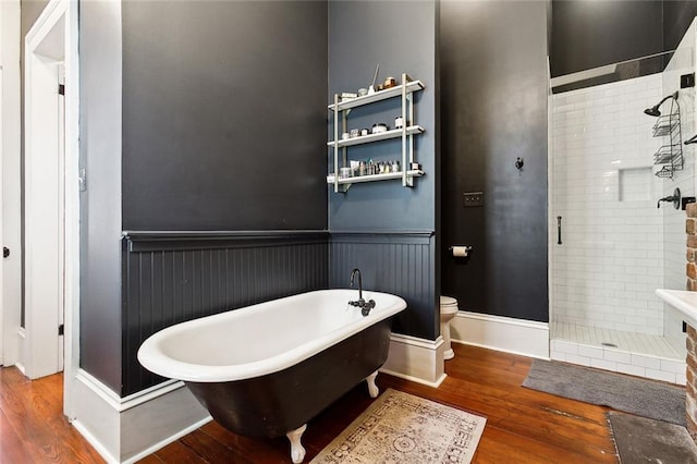 bathroom featuring wood-type flooring, toilet, and separate shower and tub