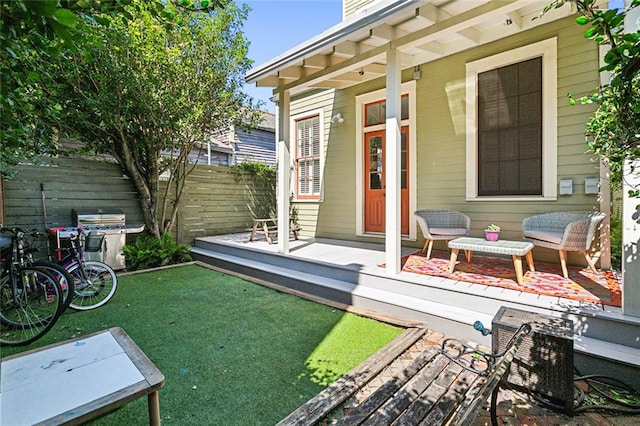 property entrance with a wooden deck and a yard