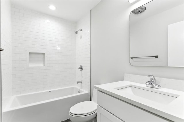 full bathroom with vanity, toilet, and tiled shower / bath