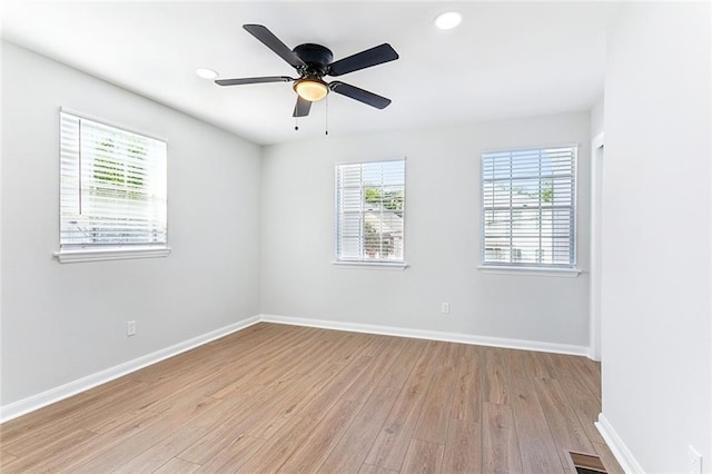 empty room with ceiling fan and light wood-type flooring