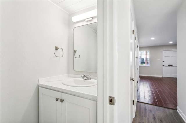 bathroom featuring hardwood / wood-style flooring and vanity