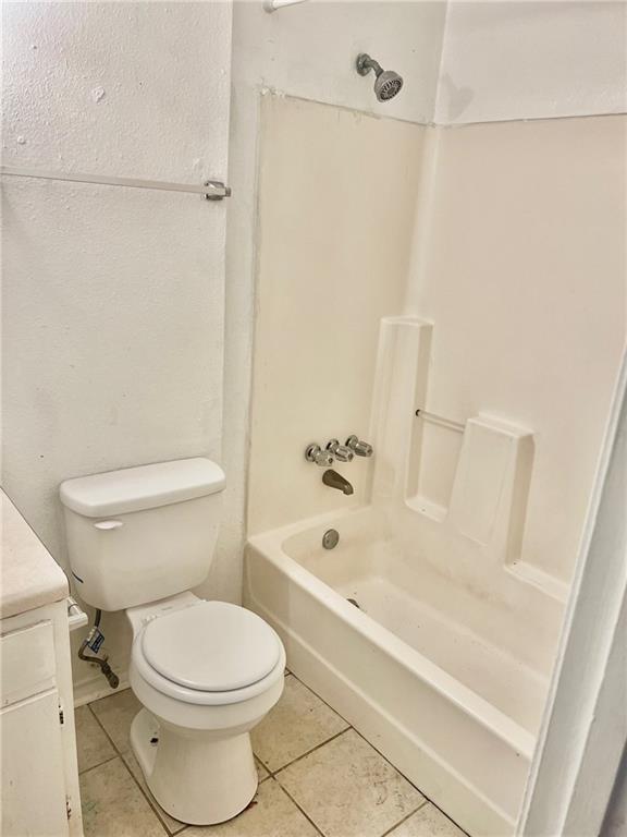 full bathroom featuring vanity, toilet, tile patterned floors, and shower / tub combination