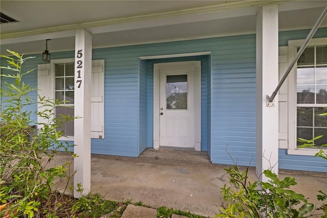 doorway to property featuring covered porch