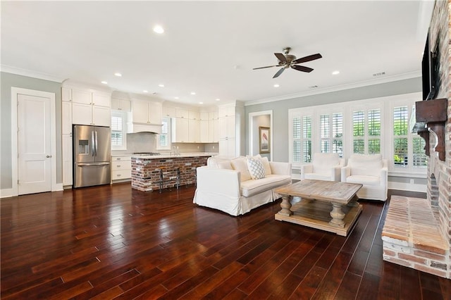 living room featuring ceiling fan, crown molding, and dark hardwood / wood-style flooring