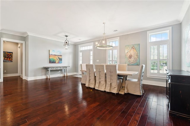 dining space with crown molding, plenty of natural light, and dark hardwood / wood-style flooring