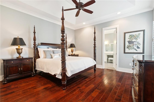 bedroom with crown molding, connected bathroom, dark hardwood / wood-style flooring, and ceiling fan