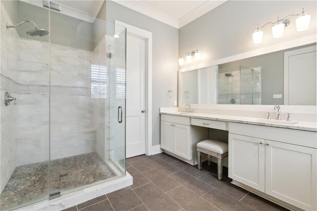 bathroom with vanity, a shower with shower door, ornamental molding, and tile patterned floors